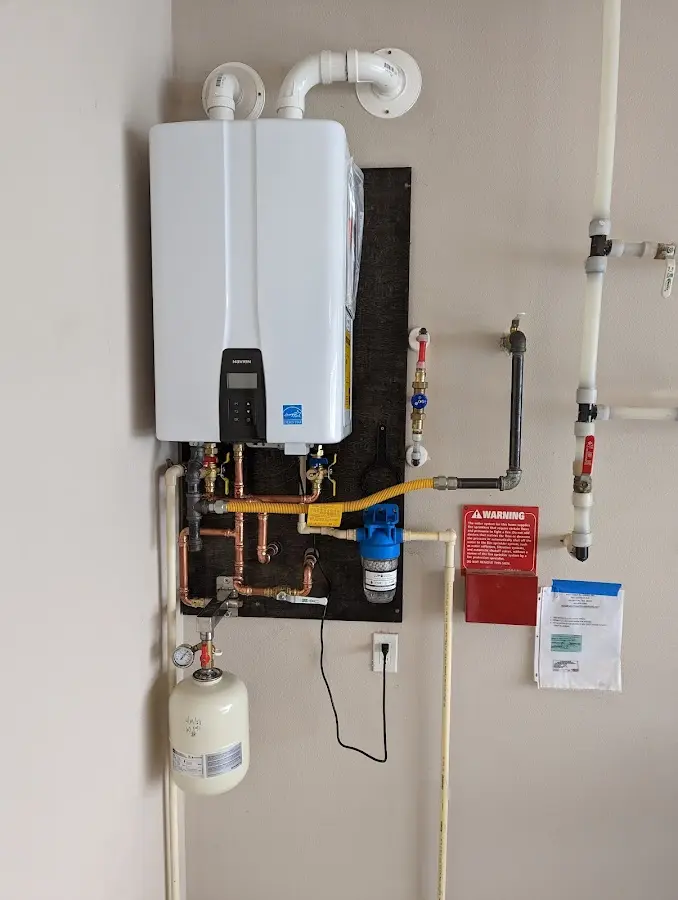 Professional plumber installing copper piping in a Homer Glen home